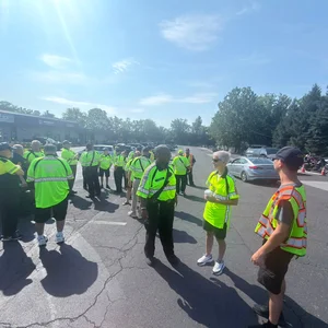 Fire police volunteers standing together in a parking lot with motorcycles nearby